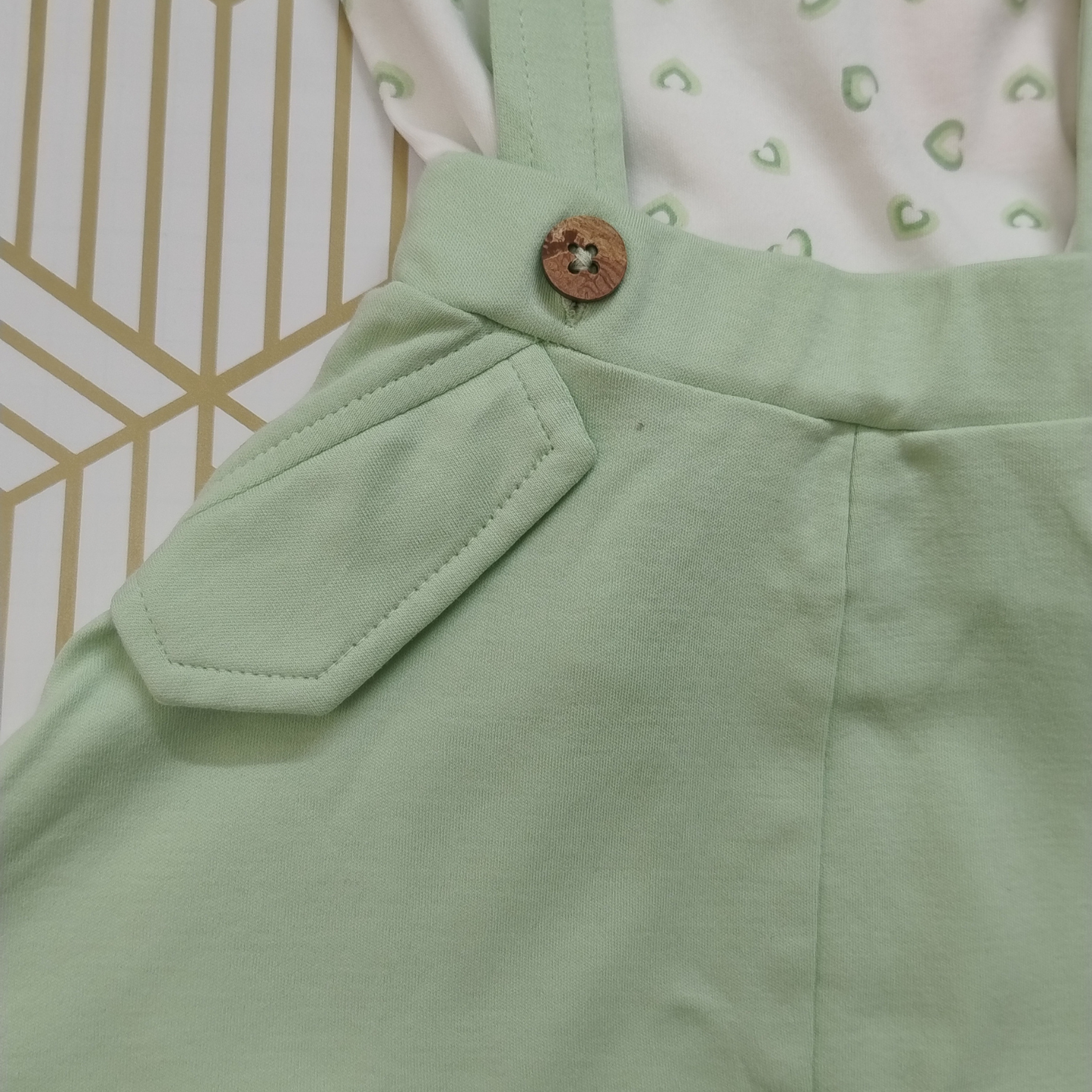 Green and white pinafore dress
